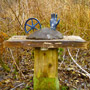 2011 12 Sculpture Yard Work George Sawchuck blue hand blue metal wheel mounted in grey form atop wood plank