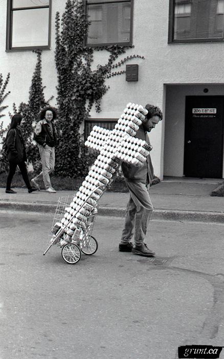 1993 04 06 Sculpture Public Works James Carl beer can cross in cart on street performance