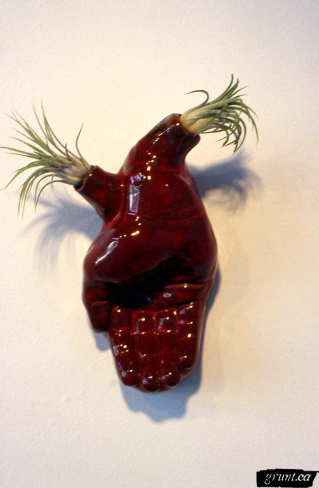2002 04 19 Sculpture Transplant Osvaldo Yero red hand sprouting grass sculpture