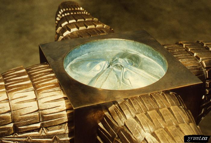 2000 02 08 Sculpture By Chisel and Mold Saul Terry overhead detail metal bird sculpture circular indentation containing four fish heads